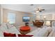 Upstairs living area with sectional couch, TV, and wicker seating overlooking a green space at 10303 Atwater Bay Dr, Winter Garden, FL 34787