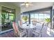View of screened patio with a ceiling fan, lake views, and furniture including a round table and four chairs at 10303 Atwater Bay Dr, Winter Garden, FL 34787