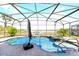 Inviting screened pool and spa with umbrella; view of lake, dock, and lush surroundings at 10303 Atwater Bay Dr, Winter Garden, FL 34787