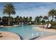 Community swimming pool with lounge chairs and tropical landscaping at 10303 Atwater Bay Dr, Winter Garden, FL 34787