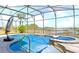 Beautiful private pool with spa, screened enclosure, and lake views, perfect for relaxation and recreation at 10303 Atwater Bay Dr, Winter Garden, FL 34787