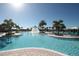 Resort-style pool surrounded by palm trees, lounge chairs, and umbrellas at 10303 Atwater Bay Dr, Winter Garden, FL 34787