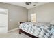 Cozy bedroom features a neutral color scheme, ceiling fan, and an en suite bathroom at 1045 Dishman Loop, Oviedo, FL 32765