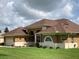 Elegant single-Gathering home with a well-manicured lawn, a fountain feature, and a two-car garage at 10648 Vista Del Sol Cir, Clermont, FL 34711