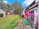 Backyard features green grass and foliage, complemented by plants and the condo's light gray siding at 1105 Woodbine St, Fern Park, FL 32730