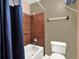 Bathroom featuring a shower with red tiling and a view of the commode area with a mounted towel rack at 1105 Woodbine St, Fern Park, FL 32730