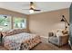 Bedroom with a leafy comforter, windows, and a plush chair, creating a cozy and inviting space at 1105 Woodbine St, Fern Park, FL 32730