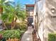 Exterior view of home featuring tropical landscaping, walkway, and secured gate at 1105 Woodbine St, Fern Park, FL 32730
