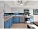 Stylish kitchen with white and blue cabinets, stainless steel appliances, and backsplash at 1105 Woodbine St, Fern Park, FL 32730