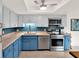 Modern kitchen featuring stainless steel appliances, blue cabinets, and light countertops at 1105 Woodbine St, Fern Park, FL 32730