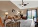 Living room with neutral color palette, ceiling fan, and sliding glass doors at 1105 Woodbine St, Fern Park, FL 32730