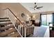 Spacious living room with high ceilings, carpeted stairs, and sliding glass doors at 1105 Woodbine St, Fern Park, FL 32730