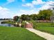 Scenic bridge leading to a Gathering-friendly playground with lush landscaping and community amenities by the lake at 1105 Woodbine St, Fern Park, FL 32730
