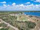 Aerial view of a beautiful community with a baseball field, football field and lake front homes and facilities at 1113 Caloosa Ridge Way, Babson Park, FL 33827