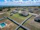Expansive properties featuring well-maintained lawns, fenced yards, and a community pool amidst serene lakeside scenery at 1113 Caloosa Ridge Way, Babson Park, FL 33827