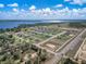 Aerial view of a serene neighborhood with single-Gathering homes and a glistening lake in the distance at 1113 Caloosa Ridge Way, Babson Park, FL 33827