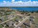 Aerial view of a waterfront community boasting new homes with modern amenities, spacious yards, and serene lake views at 1113 Caloosa Ridge Way, Babson Park, FL 33827