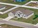 Aerial view of a single-story home showcasing its well-maintained lawn and stone-accented facade at 1113 Caloosa Ridge Way, Babson Park, FL 33827