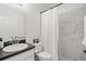 Well-lit bathroom with marble shower, white vanity, and modern fixtures at 1113 Caloosa Ridge Way, Babson Park, FL 33827