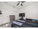 Well-lit bedroom featuring a ceiling fan, contemporary furniture, and ample space, providing a comfortable and stylish sanctuary at 1113 Caloosa Ridge Way, Babson Park, FL 33827