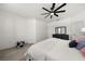 Spacious bedroom featuring a ceiling fan, wood-look floors, dresser, and decorative monochrome accents at 1113 Caloosa Ridge Way, Babson Park, FL 33827