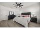 Bright bedroom featuring a large bed with stylish furnishings, neutral color palette, and modern ceiling fan at 1113 Caloosa Ridge Way, Babson Park, FL 33827