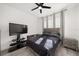Cozy bedroom with a ceiling fan, sleek furniture, and plenty of natural light, creating a relaxing retreat at 1113 Caloosa Ridge Way, Babson Park, FL 33827