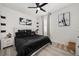 Modern bedroom featuring a black bedding set, light wood floors, and unique black shelving accents at 1113 Caloosa Ridge Way, Babson Park, FL 33827