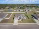 A well-manicured single-Gathering home boasts professional landscaping, a paved driveway, and attached two car garage at 1113 Caloosa Ridge Way, Babson Park, FL 33827