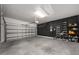 Spacious garage with black accent wall, metal shelving, and ample storage space at 1113 Caloosa Ridge Way, Babson Park, FL 33827