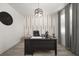 Stylish home office featuring a modern desk, unique wall accents, and contemporary lighting fixture at 1113 Caloosa Ridge Way, Babson Park, FL 33827