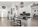 Modern kitchen featuring a sleek black countertop island with pendant lighting and white cabinetry at 1113 Caloosa Ridge Way, Babson Park, FL 33827