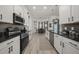 Contemporary kitchen with white cabinets, black granite countertops, and stainless steel appliances at 1113 Caloosa Ridge Way, Babson Park, FL 33827