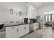 Bright kitchen with a black island, stainless steel appliances, white cabinets and an open living space at 1113 Caloosa Ridge Way, Babson Park, FL 33827