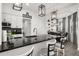 Stylish kitchen with a black countertop island, pendant lighting, and adjacent dining area at 1113 Caloosa Ridge Way, Babson Park, FL 33827