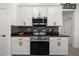 Well-equipped kitchen featuring stainless steel appliances, granite countertops, and white cabinets at 1113 Caloosa Ridge Way, Babson Park, FL 33827