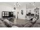 Spacious and open living area with a large sectional couch adjacent to a modern kitchen at 1113 Caloosa Ridge Way, Babson Park, FL 33827