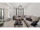 Bright living room with natural light, stylish sofas, and contemporary decor, perfect for relaxing and entertaining guests at 1113 Caloosa Ridge Way, Babson Park, FL 33827