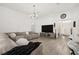Spacious living room features an oversized sectional sofa and large television at 1113 Caloosa Ridge Way, Babson Park, FL 33827