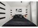 Contemporary bedroom featuring stylish black bedding, modern decor, and bright natural light from the window at 1113 Caloosa Ridge Way, Babson Park, FL 33827
