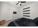 Comfortable bedroom with black bedding, ample storage, and contemporary design features at 1113 Caloosa Ridge Way, Babson Park, FL 33827