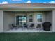 Inviting covered patio features comfortable seating and a grill, ideal for outdoor gatherings and backyard enjoyment at 1113 Caloosa Ridge Way, Babson Park, FL 33827