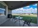 Relaxing covered patio featuring a table and chairs, perfect for outdoor entertaining and enjoying the backyard view at 1113 Caloosa Ridge Way, Babson Park, FL 33827