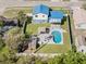 Aerial view of the in-ground pool, seating, gazebo and outdoor shed surrounded by a well-maintained lawn at 1189 Lazy Hollow Pl, Winter Park, FL 32792