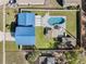 Aerial view of the backyard, highlighting the pool, patio furniture, and outdoor shed surrounded by a well-maintained lawn at 1189 Lazy Hollow Pl, Winter Park, FL 32792