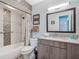 Well lit bathroom features updated vanity with granite countertops and shower/tub combo at 1189 Lazy Hollow Pl, Winter Park, FL 32792