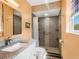 Modern bathroom featuring granite countertops, tiled shower with accessibility features, and neutral wall colors at 1189 Lazy Hollow Pl, Winter Park, FL 32792