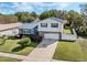Charming home with a blue metal roof, stone accents, and well-maintained landscaping at 1189 Lazy Hollow Pl, Winter Park, FL 32792
