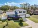 Beautiful exterior view with a well-manicured lawn and metal roof at 1189 Lazy Hollow Pl, Winter Park, FL 32792