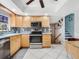 Well-lit kitchen with stainless steel appliances, stylish backsplash, and bright cabinetry at 1189 Lazy Hollow Pl, Winter Park, FL 32792